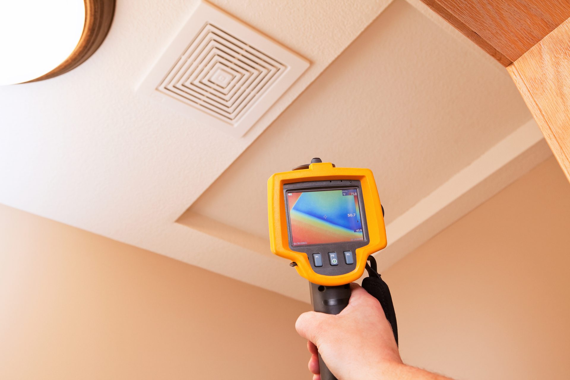 Thermal camera checking a ceiling vent during a home energy analysis