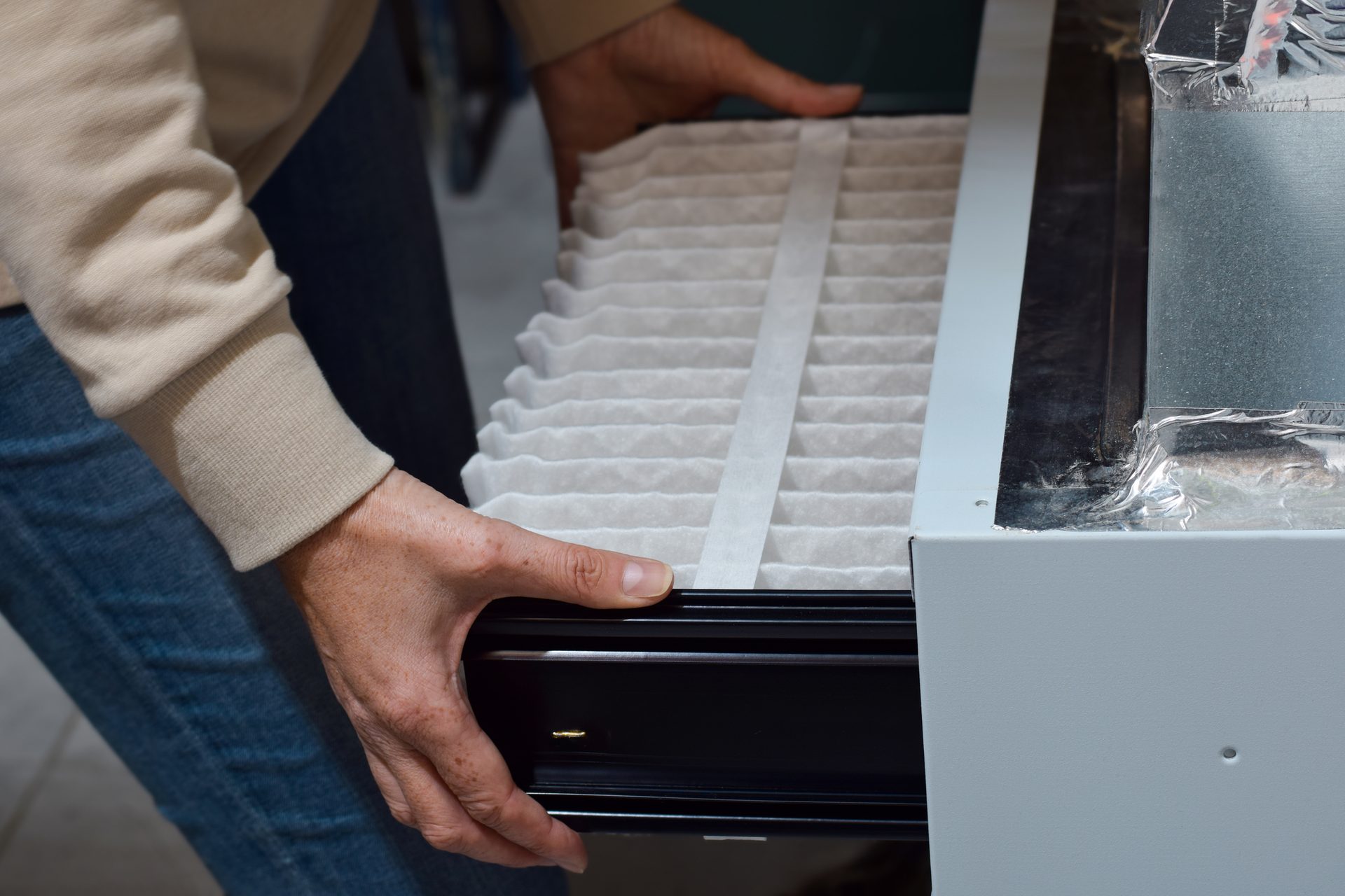 Replacing an HVAC air filter to improve indoor air quality