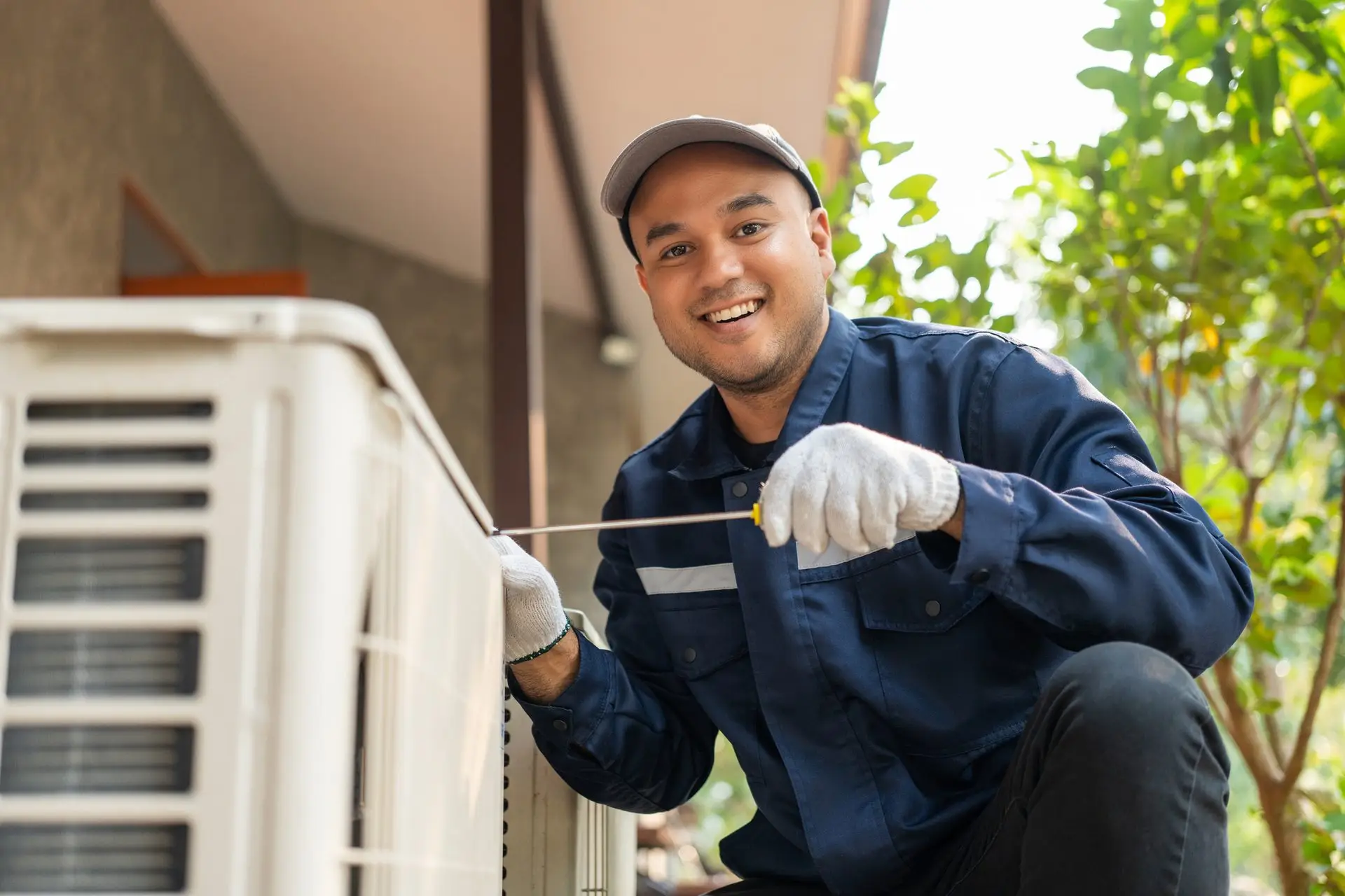 Technician working on a ductless mini split outdoor unit